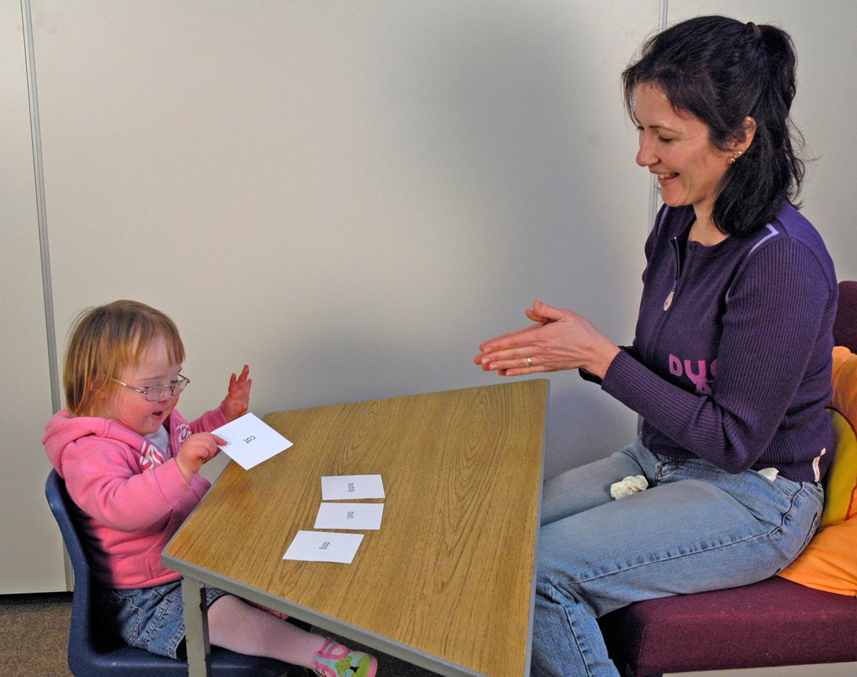 Picture of a child with Down syndrome selecting sight words