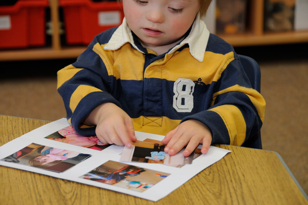 A child matching picture cards
