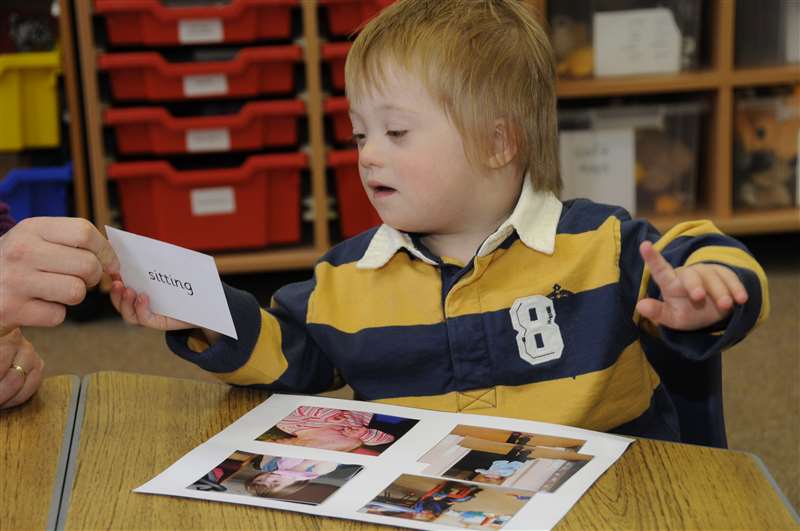 A photograph of a child with Down syndrome matching pictures.